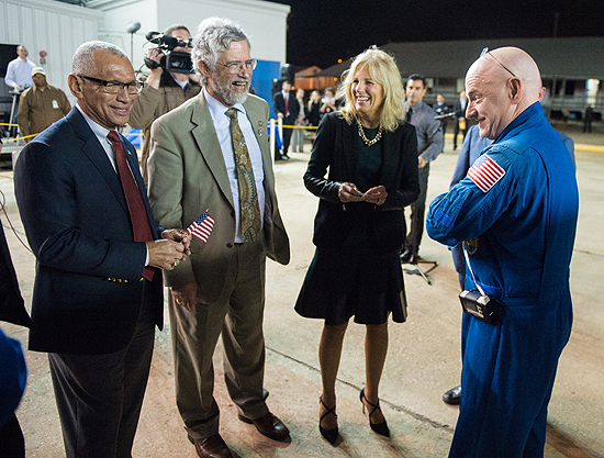 Expedition 46 Commander Scott Kelly of NASA, right, is seen with NASA Administrator Charles Bolden, left, Dr. John Holdren, director of the White House Office of Science and Technology, second from left, and Dr. Jill Biden, wife of Vice President Joe Biden, second from right, after returning to Ellington Field, Thursday, March 3, 2016 in Houston, Texas after his return to Earth. Kelly and Flight Engineers Mikhail Kornienko and Sergey Volkov of Roscosmos landed in their Soyuz TMA-18M capsule in Kazakhstan on March 1 (Eastern time). Kelly and Kornienko completed an International Space Station record year-long mission as members of Expeditions 43, 44, 45, and 46 to collect valuable data on the effect of long duration weightlessness on the human body that will be used to formulate a human mission to Mars. Volkov returned after spending six months on the station. Photo Credit: (NASA/Joel Kowsky)