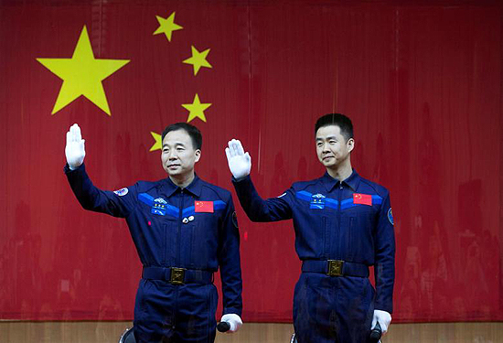 Shenzhou, Kinija, erdvėlaivis, Chinese astronauts Jing Haipeng (L) and Chen Dong wave at a news conference before China launches the Shenzhou 11 manned spacecraft, in Jiuquan, China, October 16, 2016. China Daily/via REUTERS